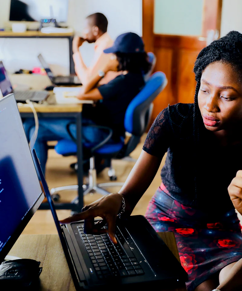 A recruiter and candidates working together at a laptop
